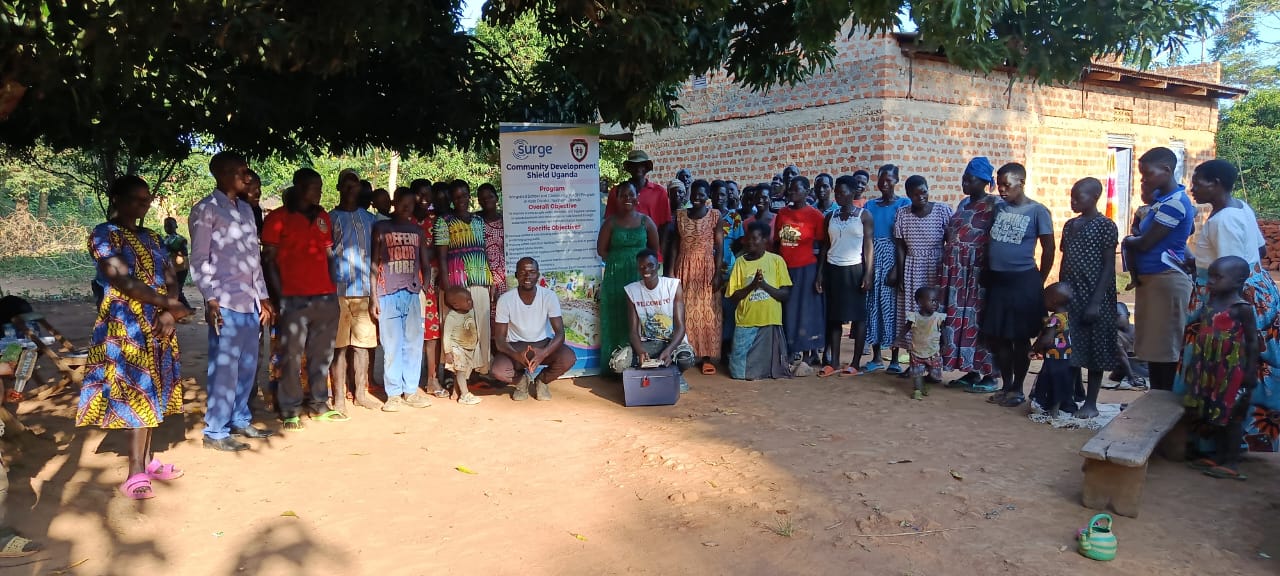 Community participants gathered beside a local programme banner